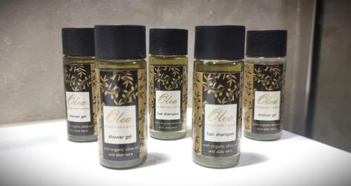 four bottles of oils sitting on a shelf at Zeus in Gázion