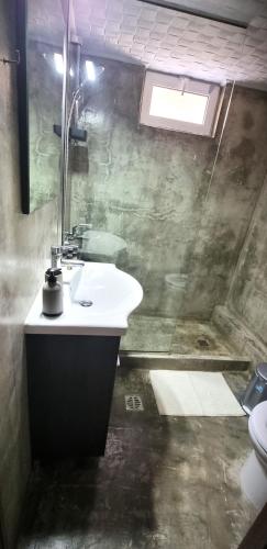 a bathroom with a sink and a toilet at Zeus in Gázion
