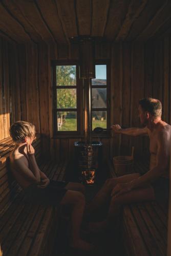 mężczyzna i kobieta siedzący w domku w obiekcie Bygagergaard w mieście Askeby
