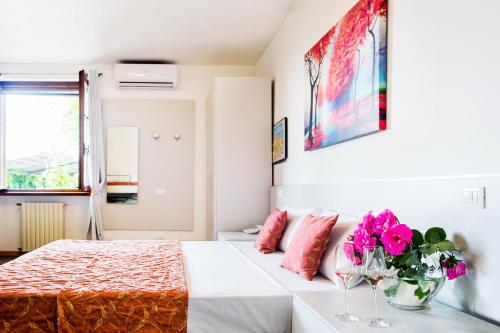 a bedroom with a large bed with pink pillows at Hotel Il Castello in Pozzolengo