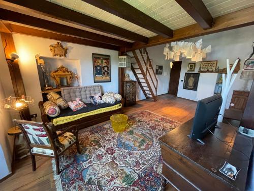 a living room with a couch and a television at La Casa di Clara nella Rocca in Farnese