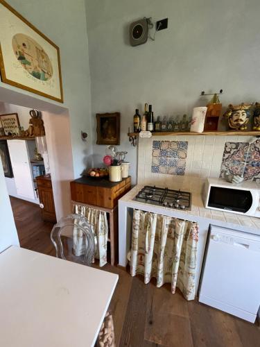 a kitchen with a stove and a counter top at La Casa di Clara nella Rocca in Farnese