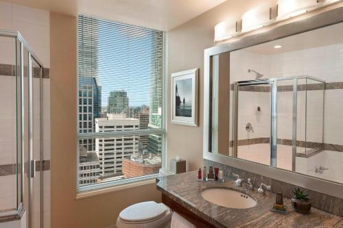 a bathroom with a sink and a large window at Vancouver Marriott Pinnacle Downtown Hotel in Vancouver