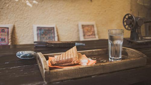 a tray of crackers and a glass of water on a table at Vagia Traditional, Aegina Island in Vaia