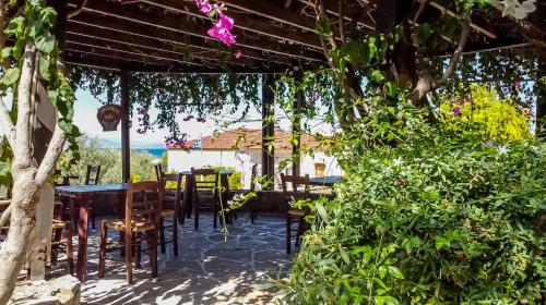 a patio of a restaurant with tables and chairs at Vagia Traditional, Aegina Island in Vaia