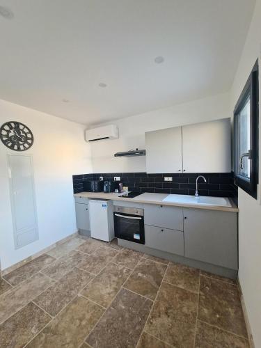 a kitchen with a sink and a dishwasher at Plages et Terres in Bessan