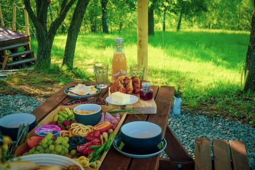 a picnic table with a bunch of food on it at Yatu in Drábsko