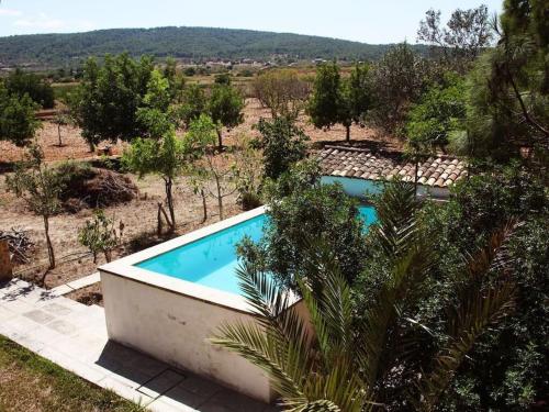 a swimming pool in the middle of a field with trees at Petit Torrent Fals in Santa Eugenia