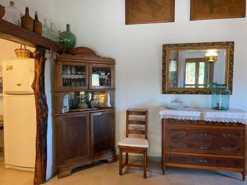 a room with a mirror and a dresser and a refrigerator at Petit Torrent Fals in Santa Eugenia
