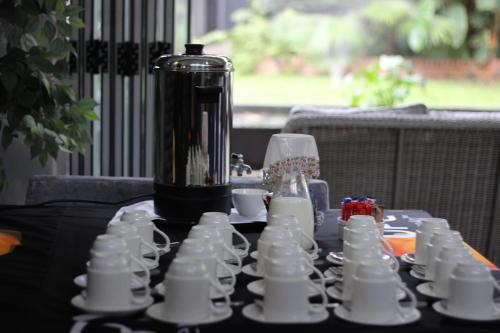 a table with cups and a blender on top of it at Ecolux Boutique Hotel in Komatipoort