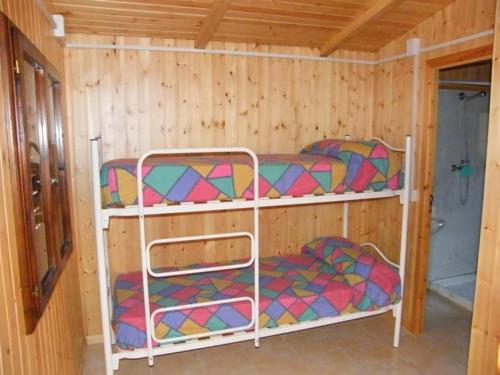 two bunk beds in a room with wooden walls at CAMPING MADDALENA in Palinuro