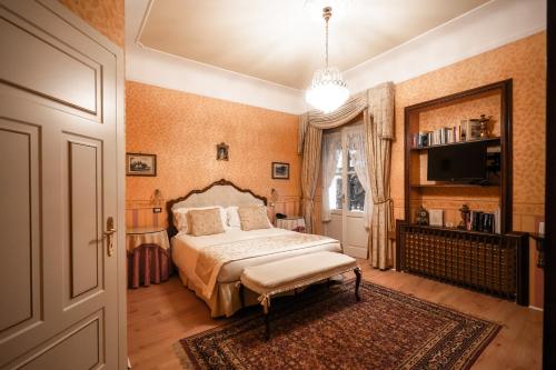 a bedroom with a bed and a large window at Castello Di Spessa - Residenze d'epoca in Capriva del Friuli