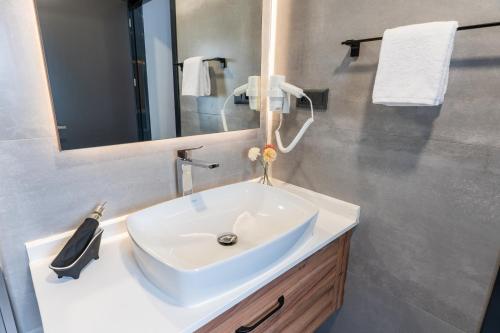 a bathroom with a white sink and a mirror at Yusufhan Suites in Trabzon