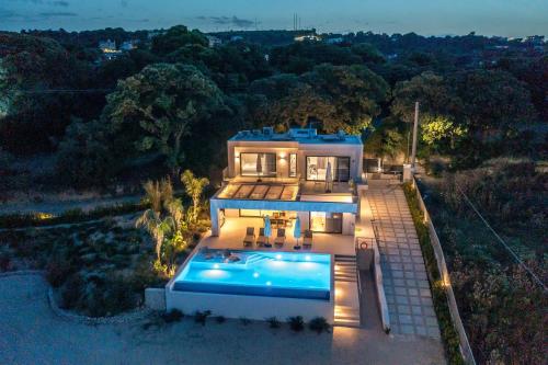 an aerial view of a house with a swimming pool at Gatsby Rhodes-Brand New Seaview Villa in Asgourou