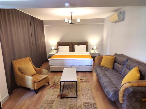 a living room with a couch and a bed at Galata World Hotel in Istanbul