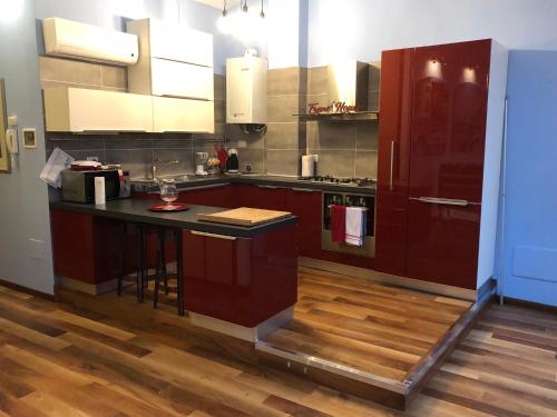 a kitchen with brown cabinets and a black counter top at Frane House in Lazise