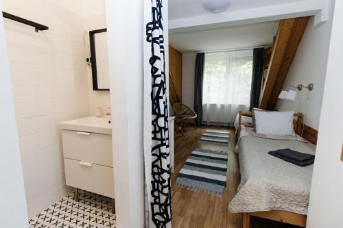 a small room with a bed and a sink at Alle Bed & Breakfast in Keszthely