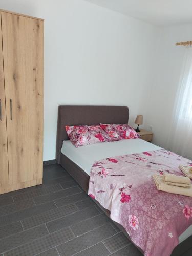 a bedroom with a bed and a wooden cabinet at Crni Bor Sutomore in Sutomore