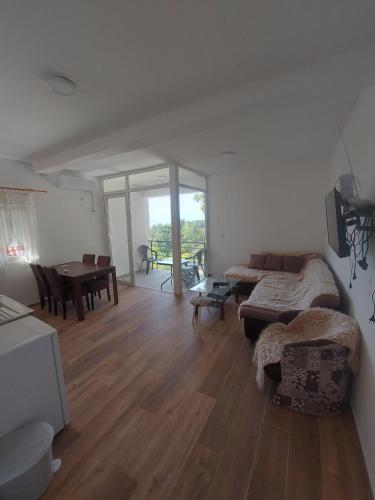 a living room with a couch and a table at Crni Bor Sutomore in Sutomore