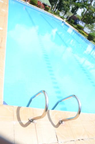 a pair of glasses sitting next to a swimming pool at WAMALA RESORT HOTEL SSESE in Kalangala