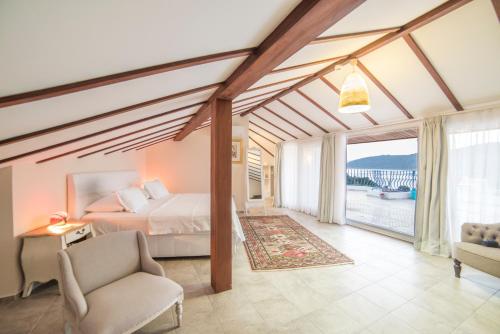 a bedroom with a bed and a large window at Yalicapkini Boutique Hotel in Gulluk