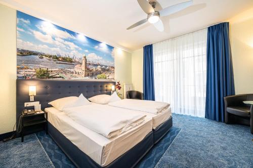 a bedroom with a large bed with a large window at Hotel Hanseport Hamburg in Hamburg