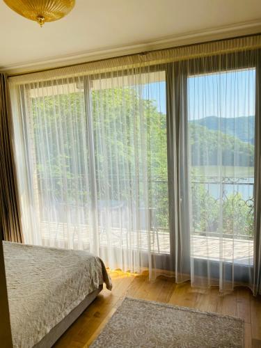 a bedroom with a large window with a view of the water at Vila Tarnita in Cluj-Napoca