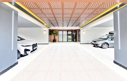 a garage with two cars parked in it at Apart HOTEL Fusion Tower in Iaşi