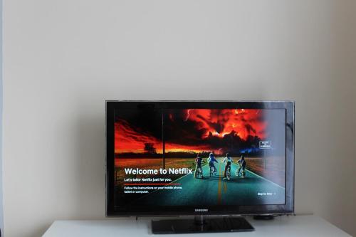 a flat screen tv sitting on top of a table at Sunny South Shields House in Jarrow