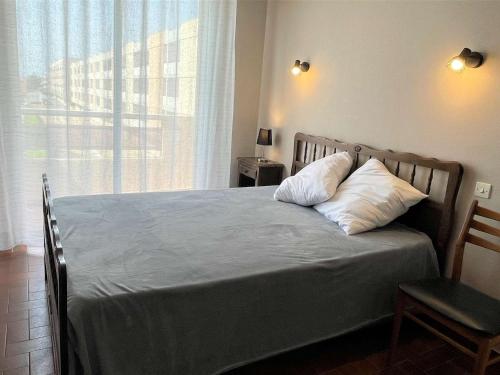 - une chambre avec un lit avec deux oreillers et une fenêtre dans l'établissement Appartement 3 pièces, 6 couchages, proche plage et centre, balcon, classé 2 étoiles, ménage inclus - FR-1-229C-608, à Port-la-Nouvelle