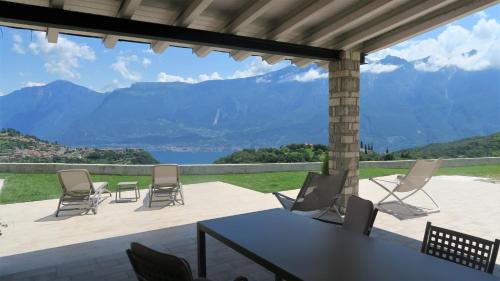 a patio with chairs and a table with a view at OASI DA VINCI in Tignale
