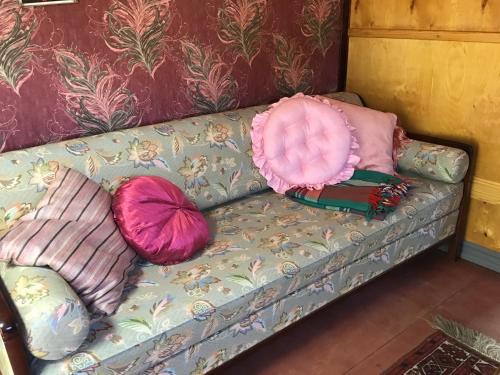 a couch with two pillows and a pink pillow at Grand Circus Hotel in Malmö