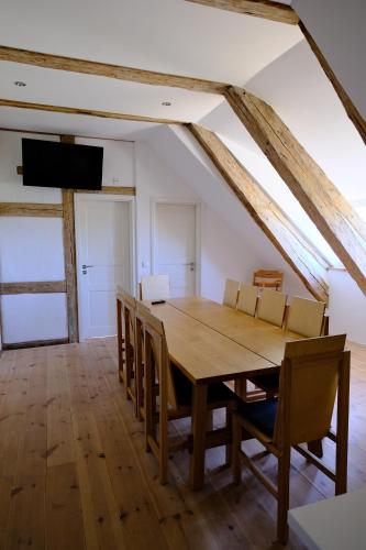 a dining room with a wooden table and chairs at Gutshaus FeWo Brook in Dassow