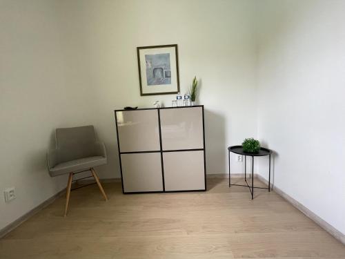 a room with a cabinet and a chair at Villa Anzio in Mariánské Lázně
