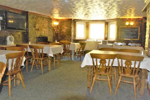 a restaurant with tables and chairs in a room at Pine Lodge Hotel in Blackpool
