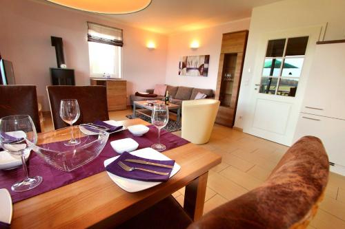 a dining room table with wine glasses on it at HAUS BELLEVUE _ EG_Fewo in Göhren-Lebbin
