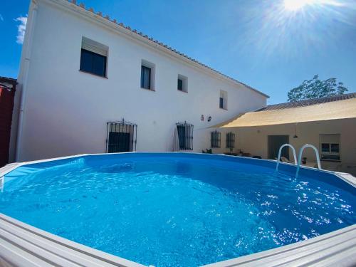 a swimming pool in front of a house at Casa Antigua Estacion By Solymar Holiday in Málaga