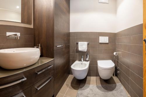 a bathroom with a sink and a toilet at Au Reduit 106 in St. Moritz