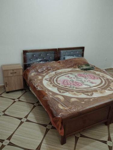 a bed with a blanket on it in a room at Residence Tazoumbirt in Tigzirt