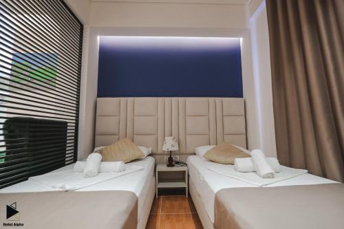 Postel nebo postele na pokoji v ubytování Hotel Alpha