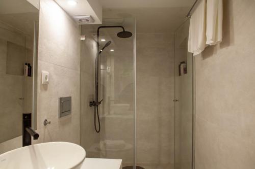 a bathroom with a shower and a toilet and a sink at 竹林书屋 in Arneiro