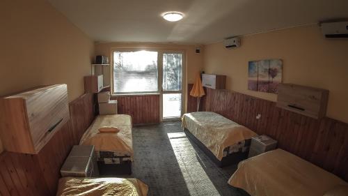a room with two beds and a window at Penzion Anička in Klokočov