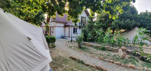 ein Zelt vor einem Haus mit einem Hof in der Unterkunft Magic Garden Emperor Bell Tent in Vama Veche