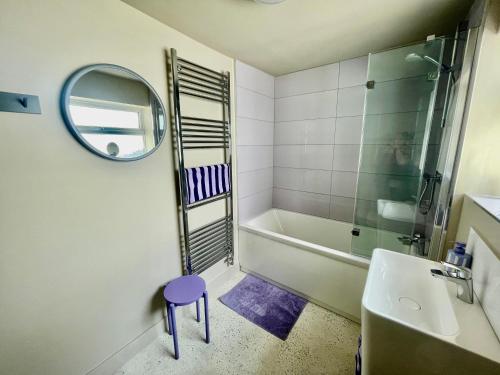 a bathroom with a mirror and a sink and a tub at Swan House - Free Parking - Ten minute walk to train station - Perfectly located for City Centre & Racecourse in York