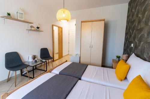 a bedroom with a bed and a table and chairs at DELUXE ROOMS BURE in Murter