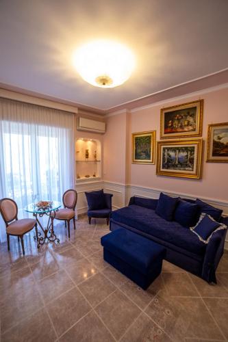 a living room with a blue couch and a table at Angel luxury Suite in Sorrento