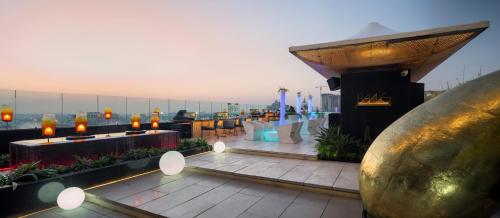a rooftop restaurant with a view of the city at The Ritz-Carlton, Bangalore in Bengaluru