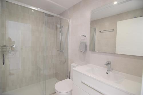 a bathroom with a shower and a toilet and a sink at Las Mimosas in La Cala de Mijas