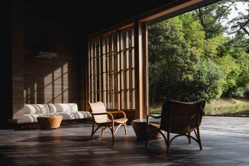 two chairs and a couch on a patio at Numazu Club in Numazu