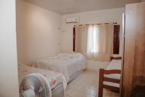 Säng eller sängar i ett rum på Aconchego - Casa 3/4 - ar condicionado nos 3/4 -garagem